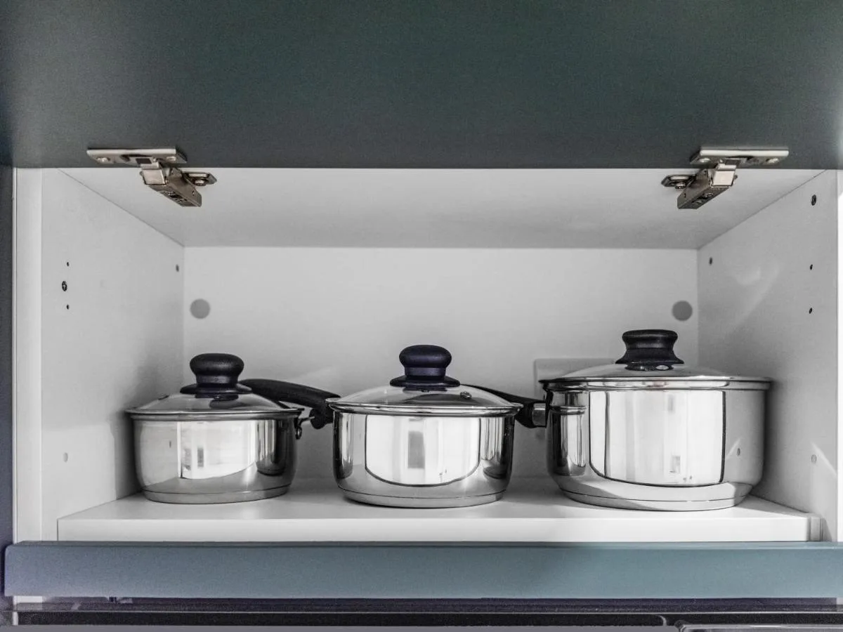 Kitchenette with pots on a shelf at Chelsea Cloisters Serviced Apartments in Chelsea, London