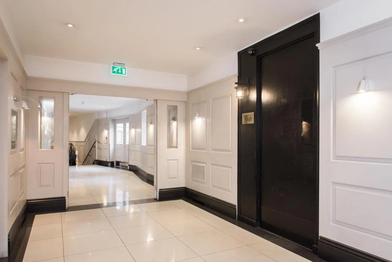 Apartment hallway with black door at Chelsea Cloisters Serviced Apartments, Chelsea