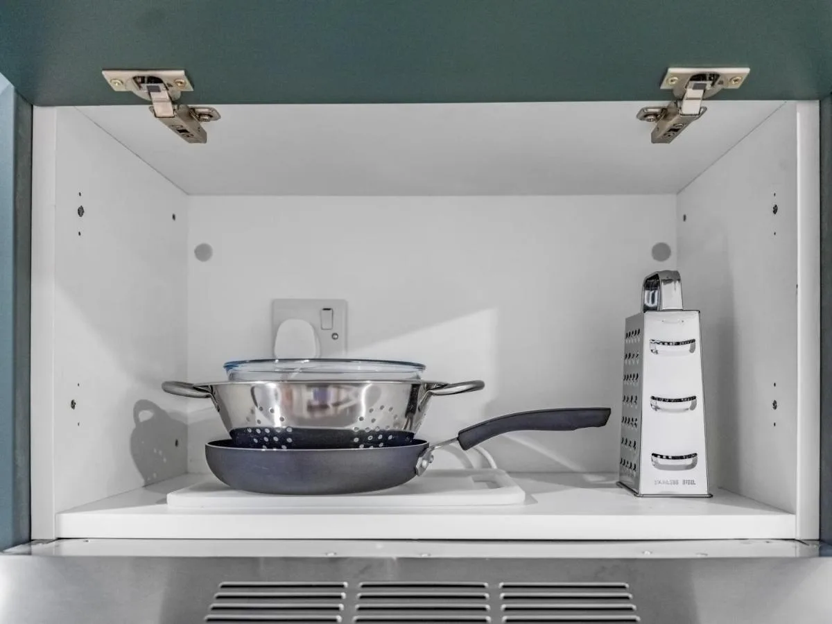 Stove and cookware in an apartment kitchen at Chelsea Cloisters Serviced Apartments