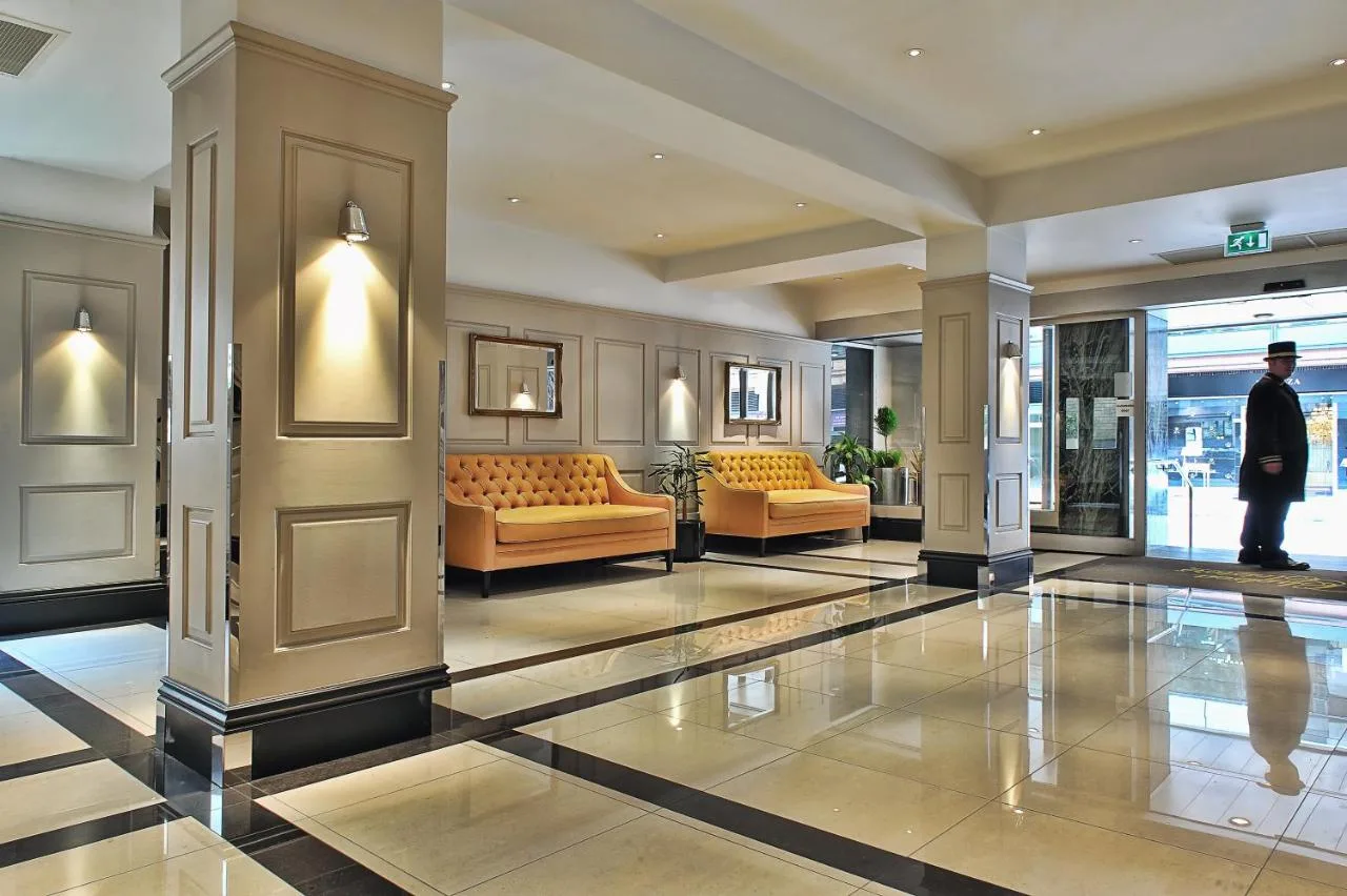 Lobby with couches and chairs at Chelsea Cloisters Serviced Apartments, Sloane Avenue