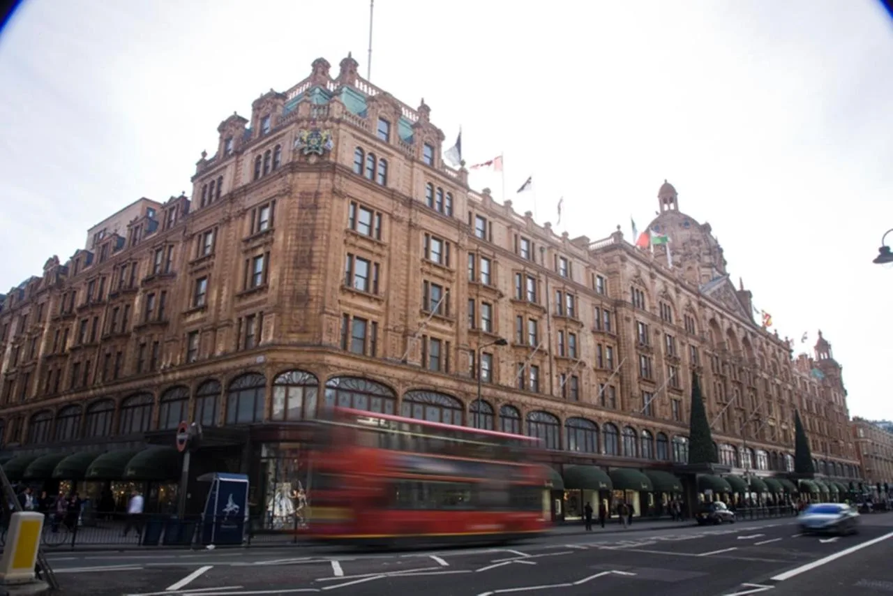 Red London bus passing Chelsea Cloisters Serviced Apartments building
